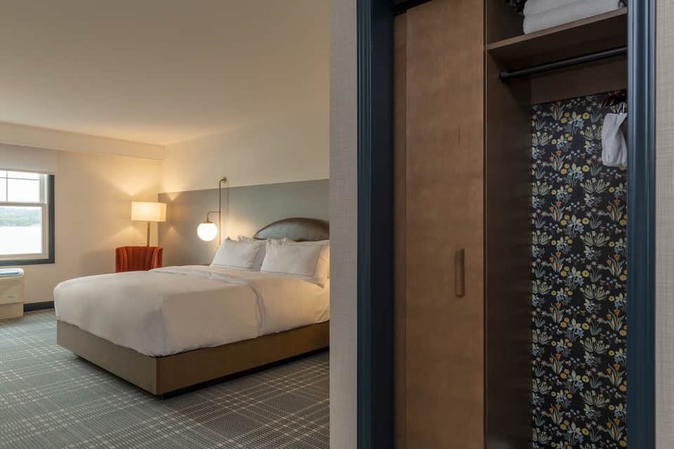 Bedroom with wood furnishings, patterned wardrobe, and warm ambient lighting