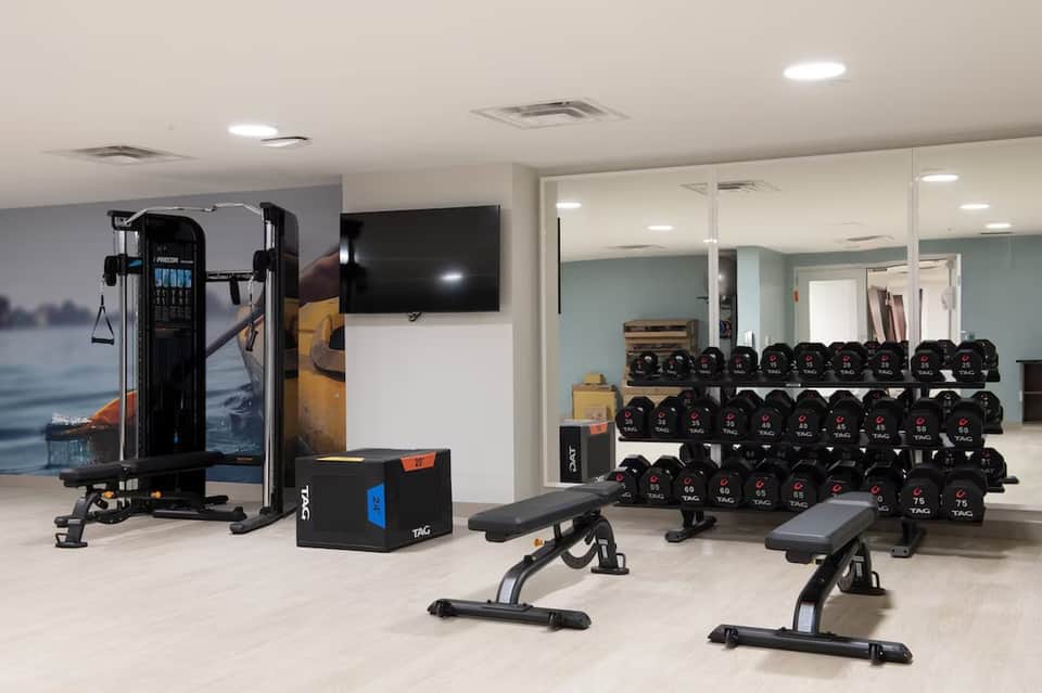 Well-equipped fitness center with weight racks, exercise machines, and gym equipment