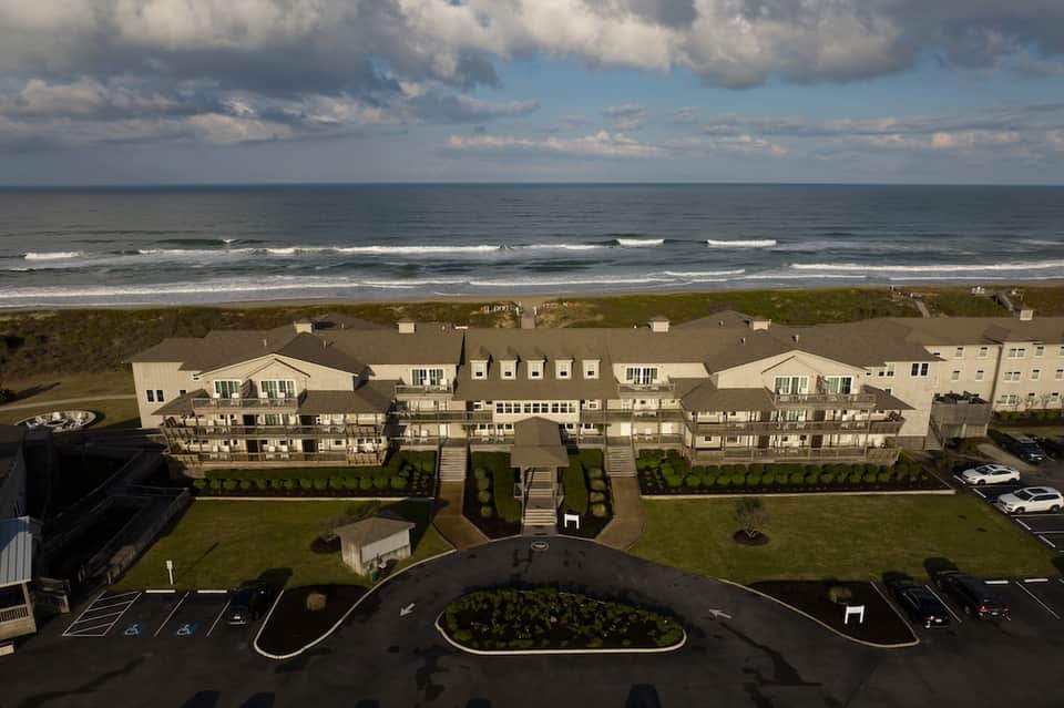 Beachfront hotel complex with oceanview terraces and manicured grounds along sandy shore