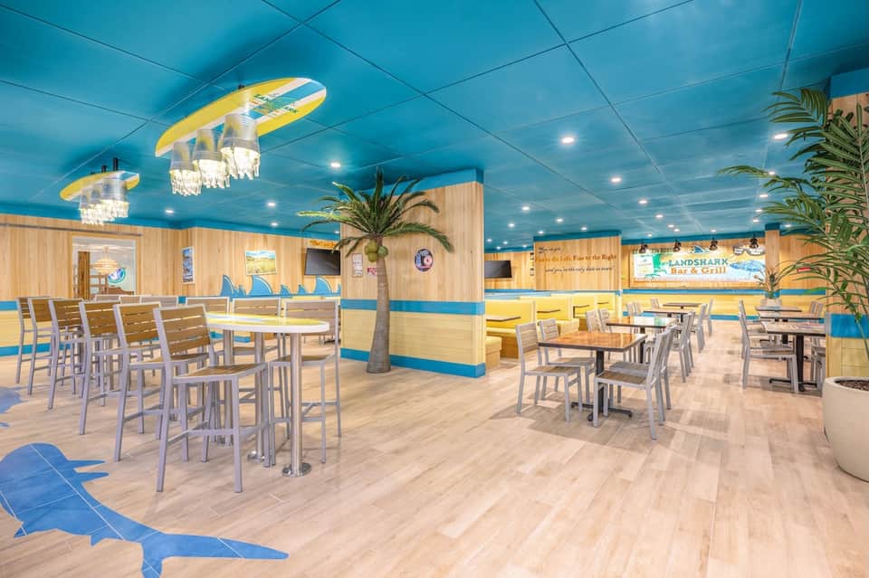 Casual dining area with blue ceiling, surfboard decor, and beach theme