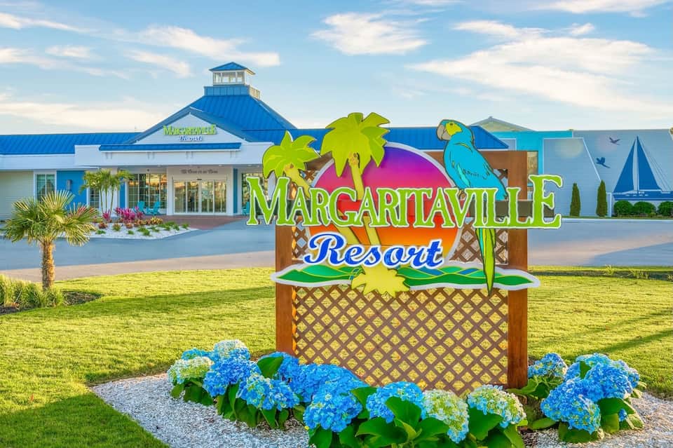 Margaritaville Resort entrance sign with bright tropical graphics and blue roof building