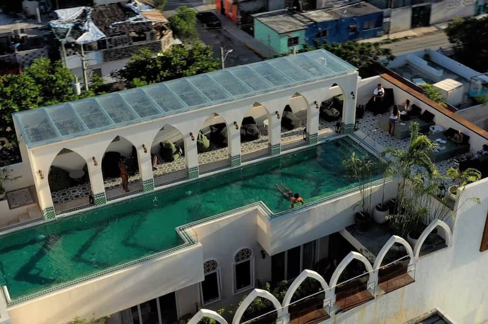 Aerial view of ornate emerald pool with arched pavilion and surrounding courtyards