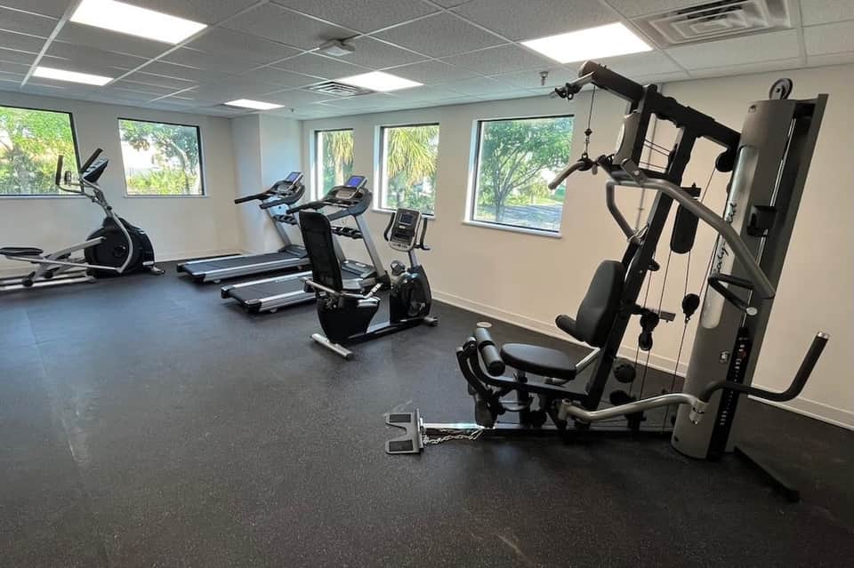 Fitness center with treadmills, exercise bikes, and weight equipment