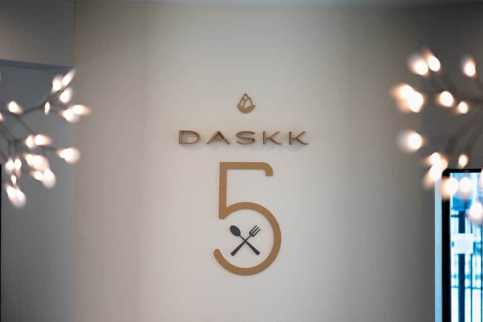 Restaurant signage reading DASKK 5 with decorative lighting