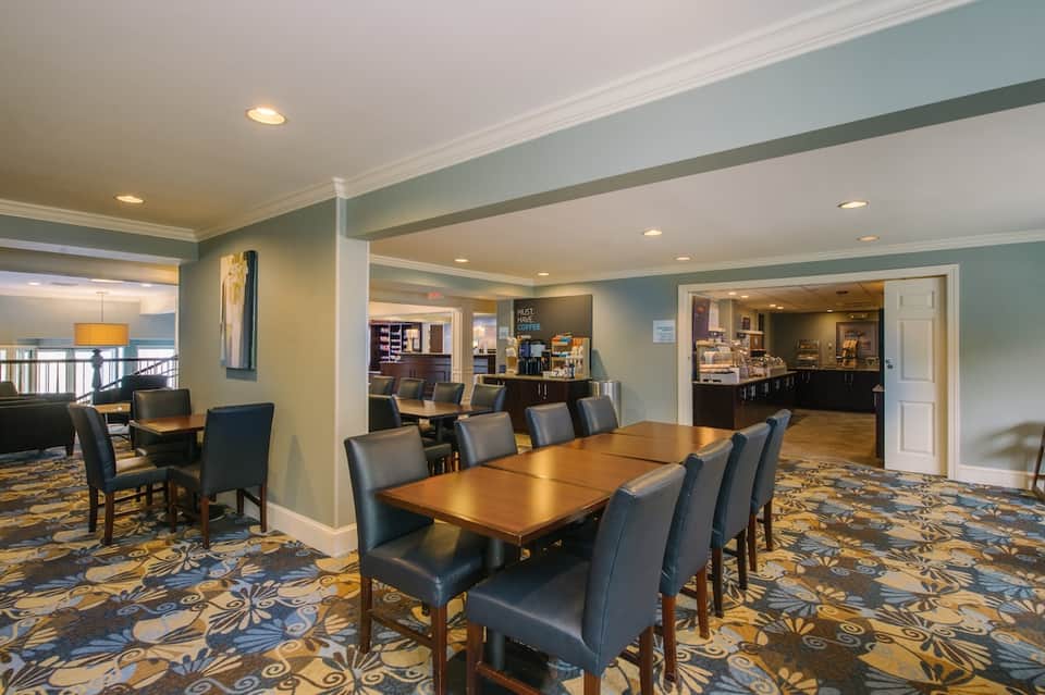 Hotel common area with dining tables and casual lounge seating