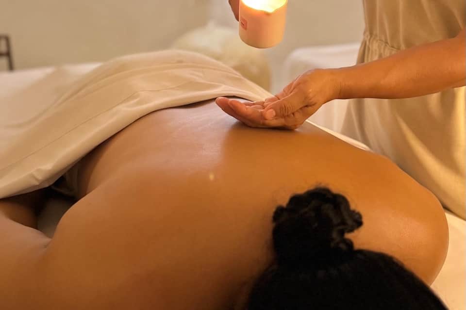Spa treatment in progress with therapist performing massage on client