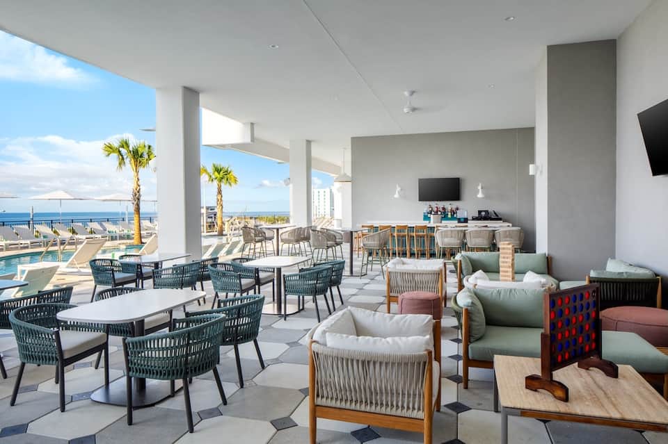 Modern oceanfront lounge with floor-to-ceiling windows and casual seating areas