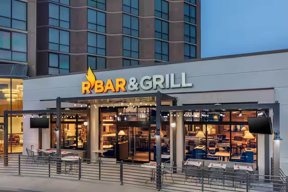 Modern RBar&Grill restaurant storefront with illuminated signage and expansive windows