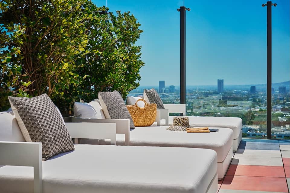 Modern terrace lounge chairs with city skyline view and contemporary outdoor furnishings