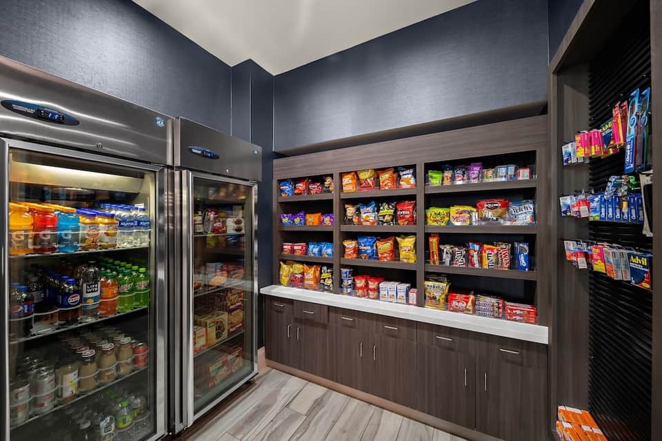 Modern convenience store with refrigerated cases, snack shelves, and organized product displays