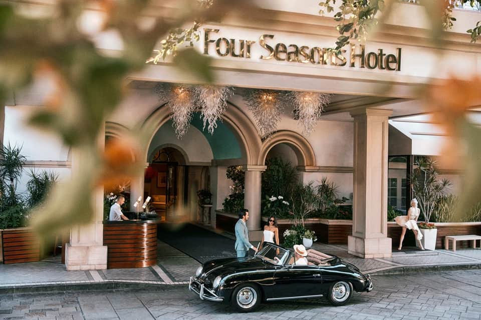 Four Seasons Hotel entrance with vintage car and uniformed staff