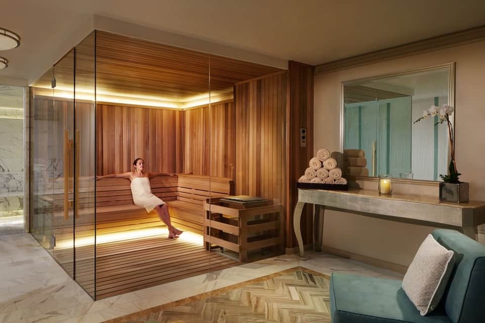 Luxury spa sauna room with cedar wood paneling and ambient lighting for relaxation