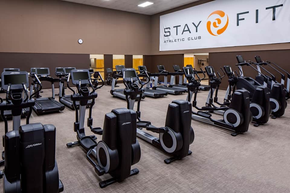 Stay Fit Athletic Club cardio room with rows of stationary bikes and exercise equipment
