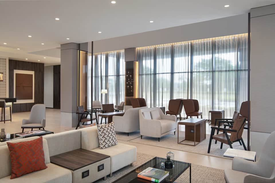 Contemporary penthouse living room with floor-to-ceiling windows and designer furnishings