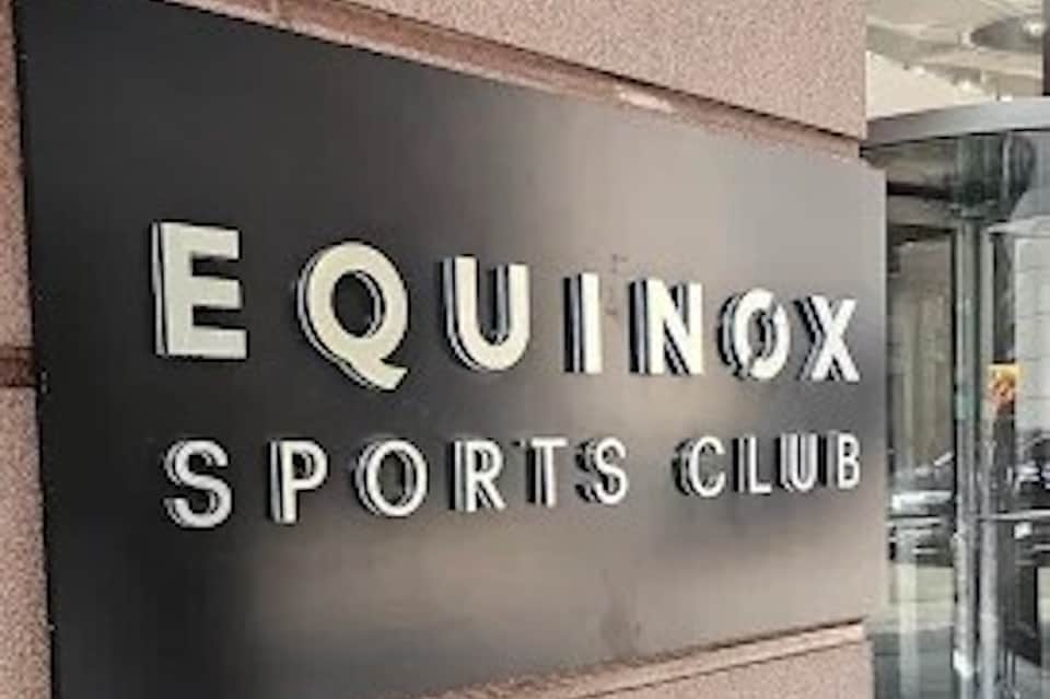 Equinox Sports Club entrance sign on brick building exterior