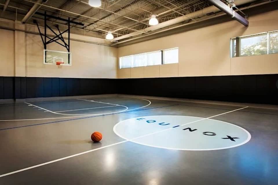 Indoor sports facility basketball court with gymnasium floor and professional lighting