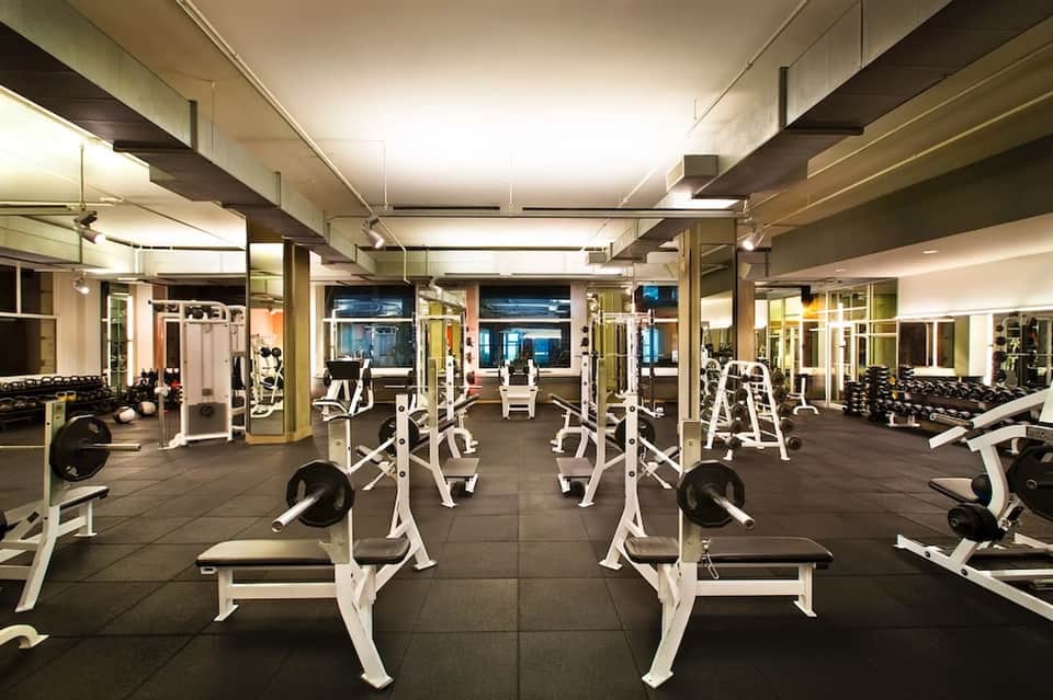 State-of-the-art fitness center with cardio equipment, mirrors, and professional workout machines