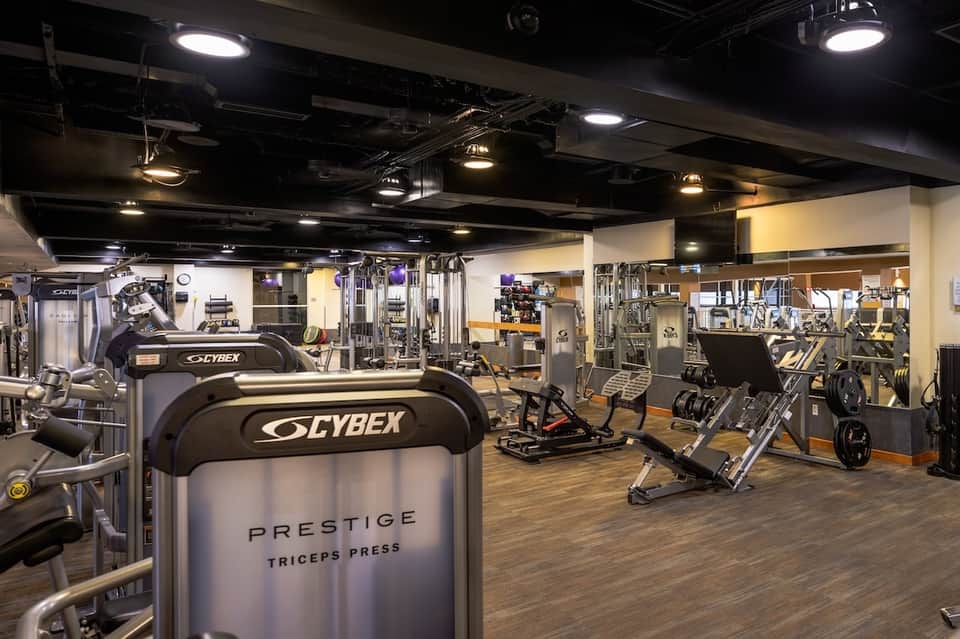 Spacious fitness center with Cybex equipment and mirrors throughout
