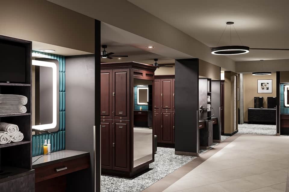 Modern spa facility hallway with dark wood cabinetry and contemporary lighting
