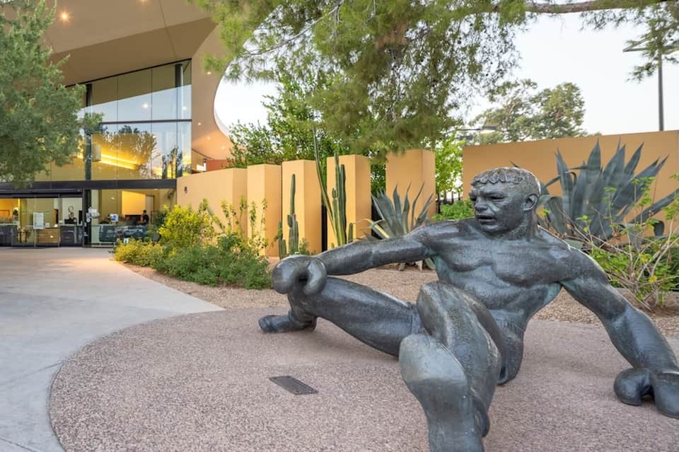Modern desert home exterior with contemporary architecture, sculpture, and desert landscaping