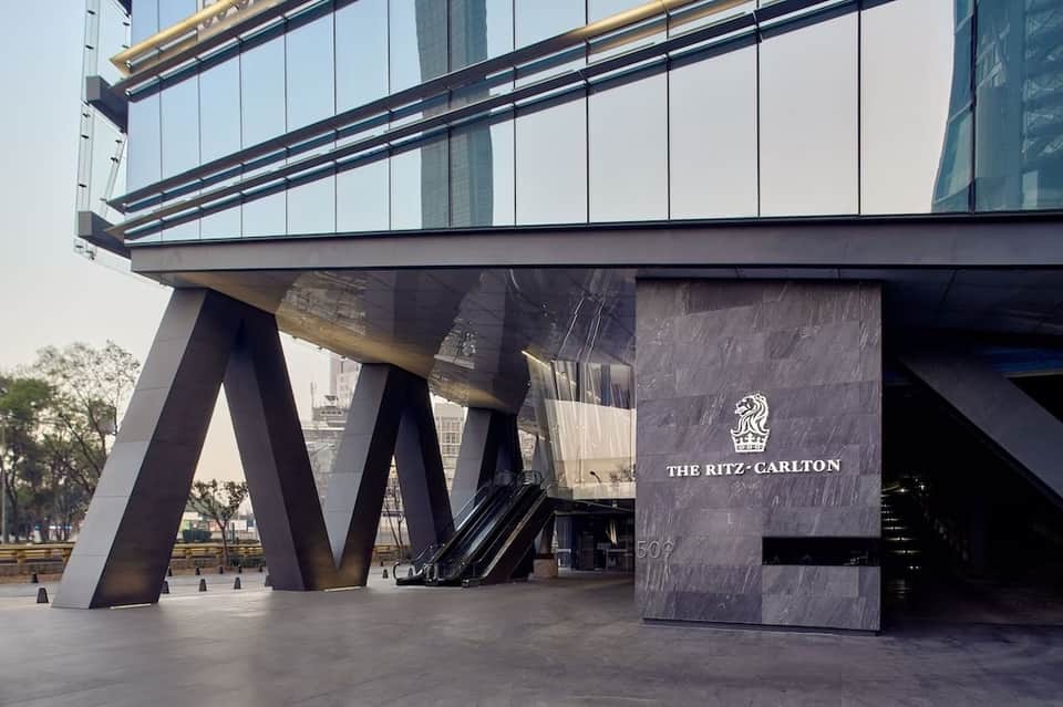 Contemporary building entrance with The Ritz-Carlton signage and geometric steel architecture