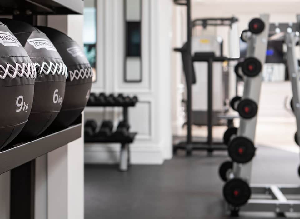 Fitness center with medicine balls and dumbbells in modern gym setting