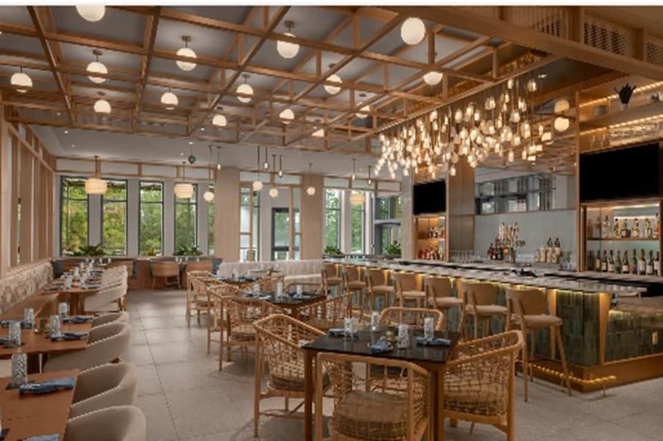 Elegant dining room with wooden ceiling details, pendant lighting, and bar area