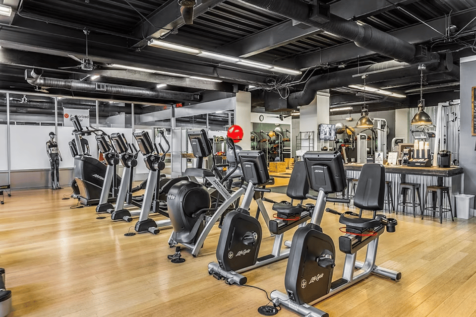 Spacious fitness center with rows of exercise bikes and modern equipment