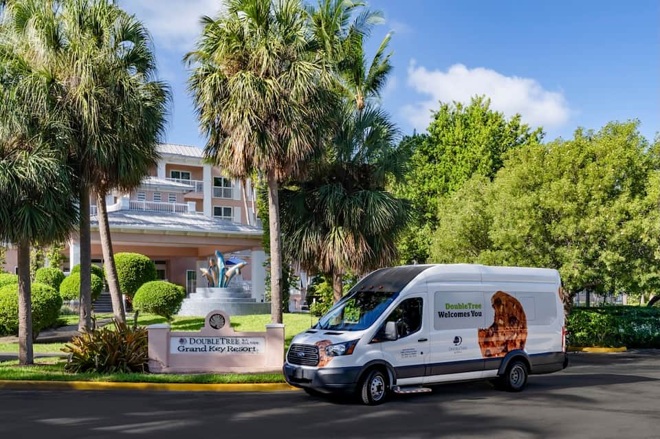 DoubleTree Grand Key Resort entrance with welcome van, palm trees, and white building