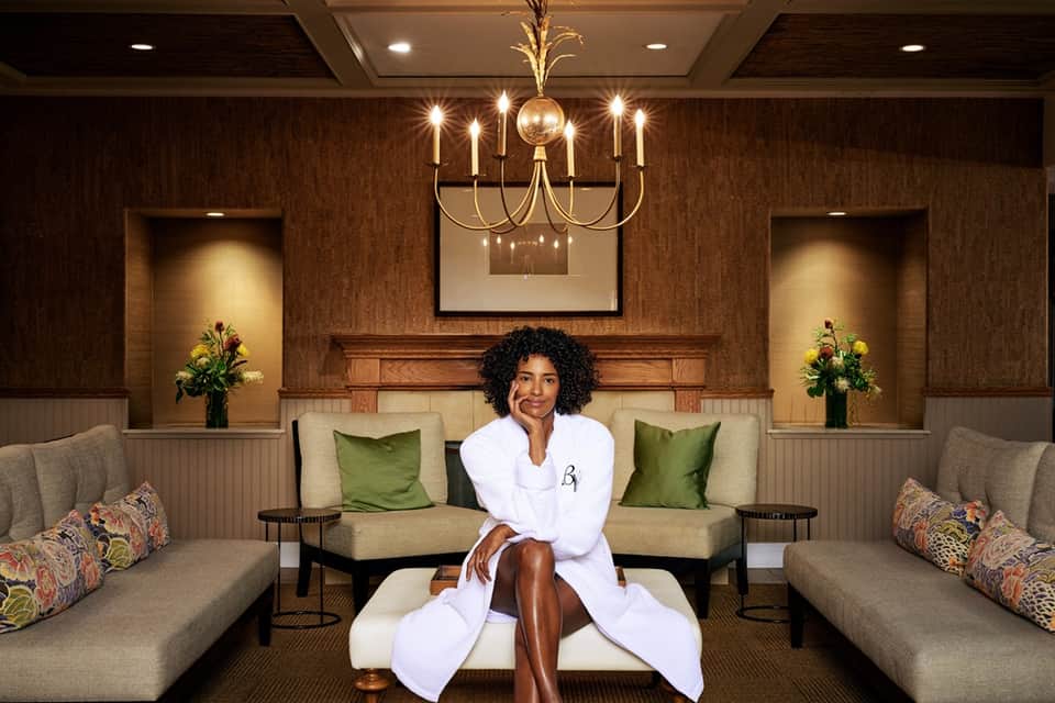 Spa relaxation room with symmetrical seating, warm lighting, and professional aesthetic