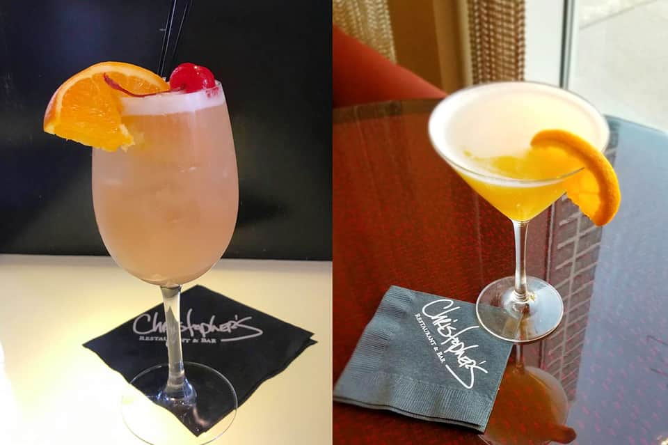 Two cocktails with citrus garnishes on branded napkins