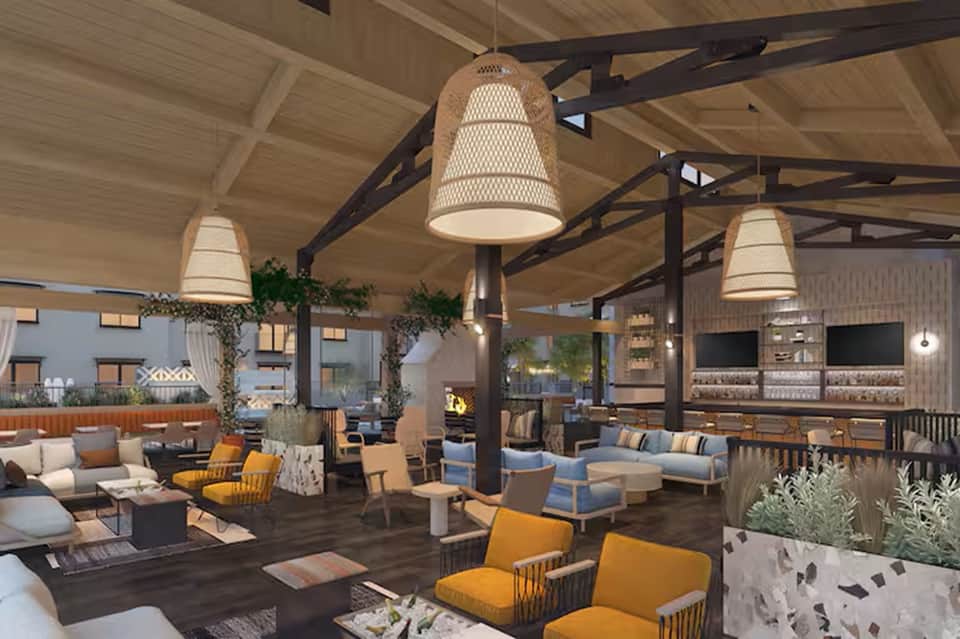 Modern outdoor resort lounge with woven pendant lights, wood beams, seating areas, bar, plants, and contemporary furnishings