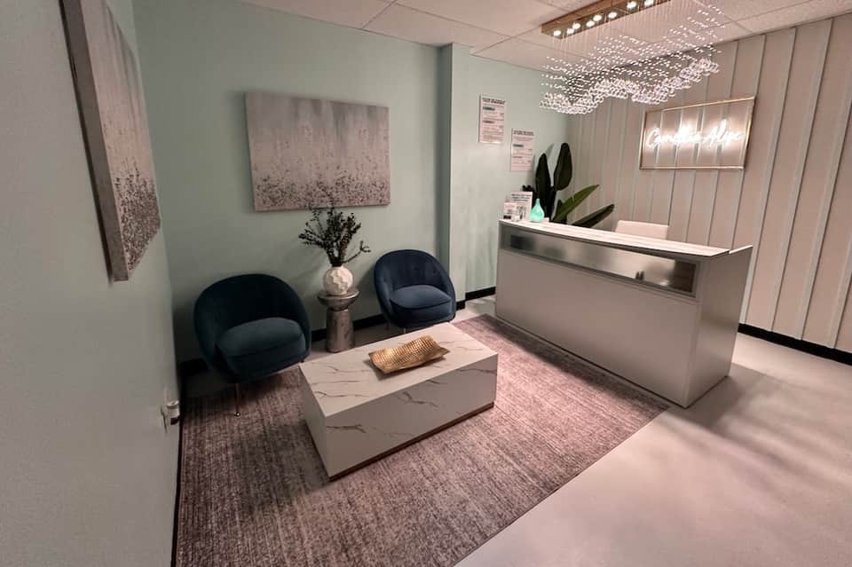 Modern hotel lobby reception area with light pink tones and minimalist design