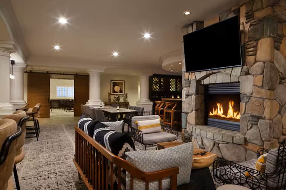 Upscale lounge with fireplace, TV, and comfortable seating areas