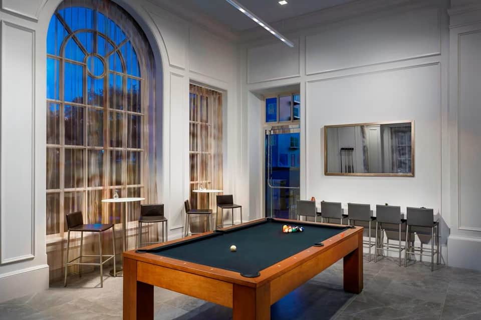 Recreation room with pool table, arched window, and contemporary seating area