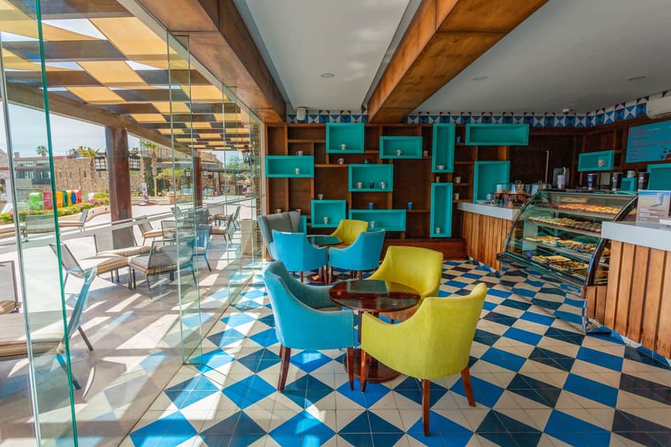 Contemporary lobby lounge with turquoise shelving and geometric floor