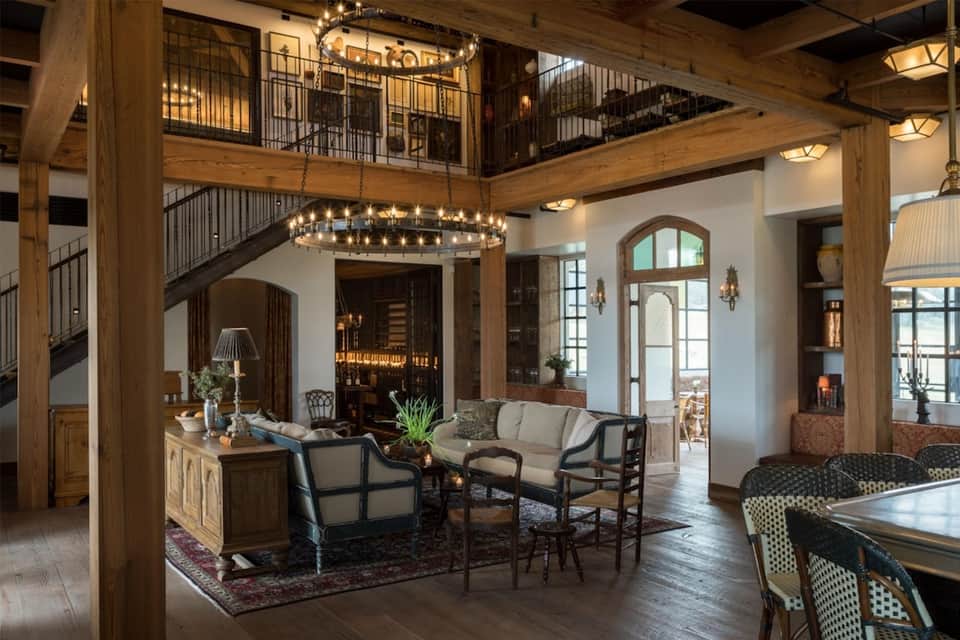 Luxury resort lobby with wooden beams, chandelier, and multi-level design