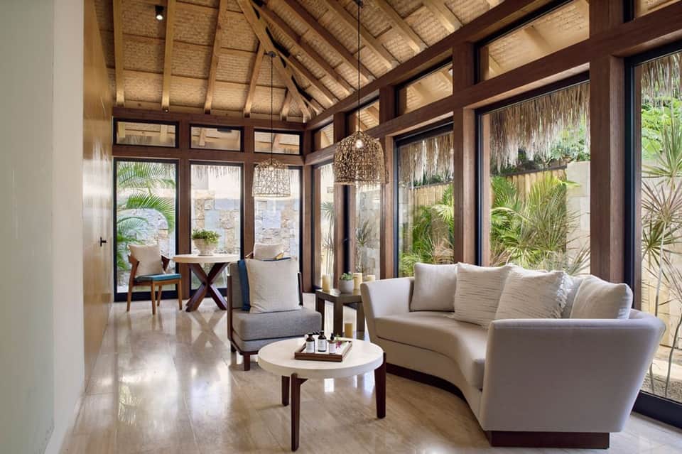 Luxury lounge area with ocean views, palm trees, and contemporary furnishings