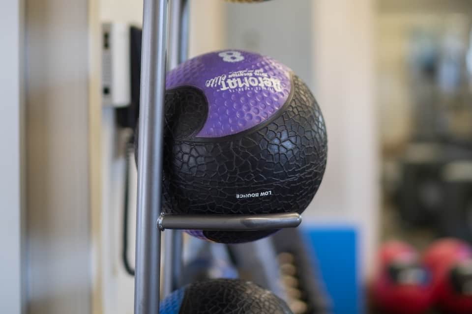Close-up of medicine ball on gym equipment rack