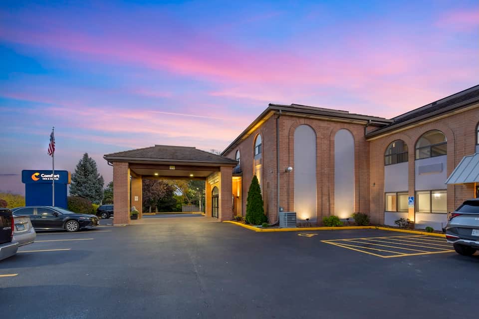 Comfort Inn exterior at twilight with brick architecture and illuminated entrance