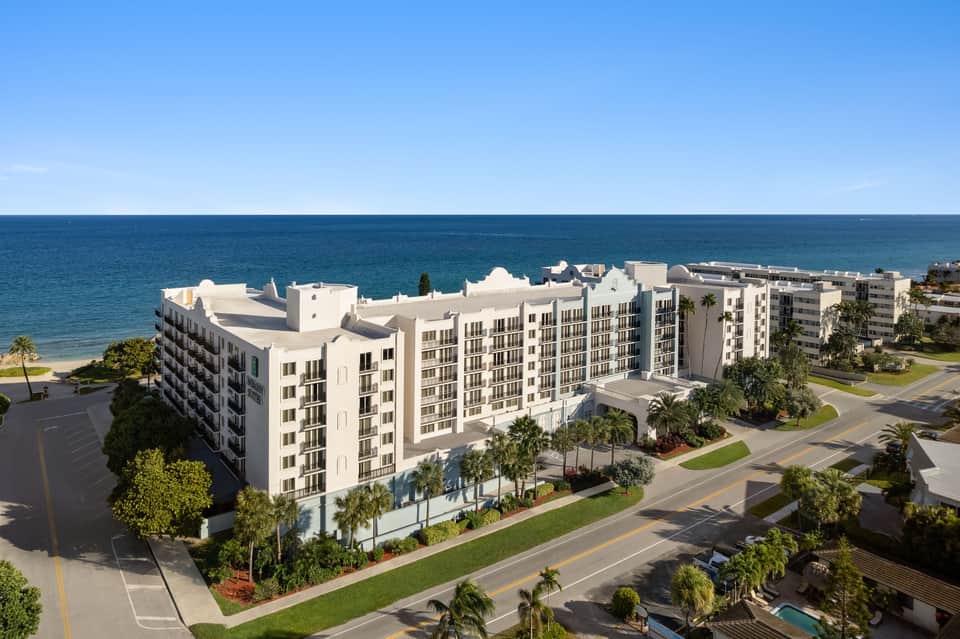 Beachfront resort building with white architecture overlooking pristine turquoise ocean waters