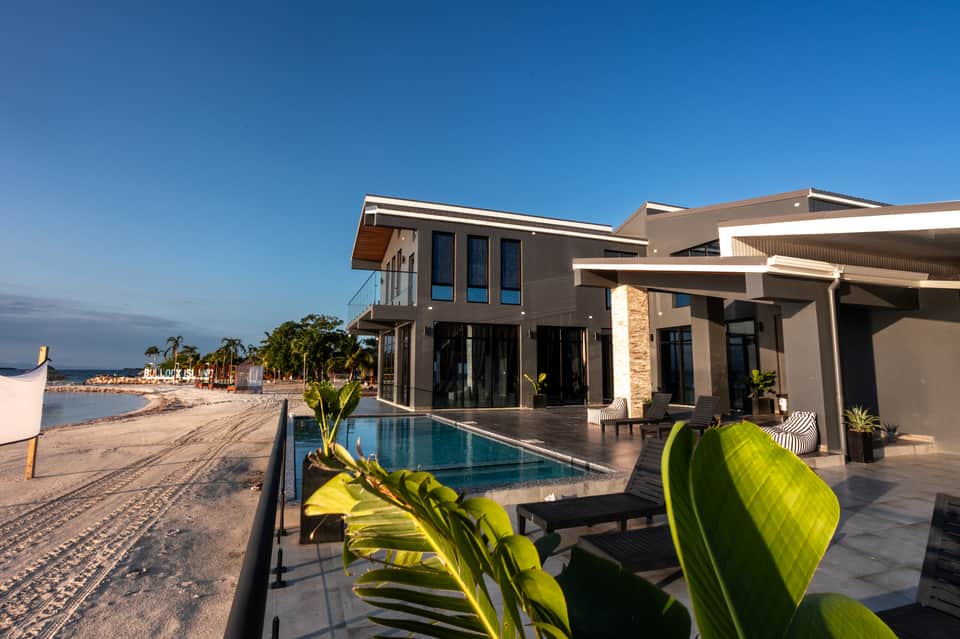 Beachfront modern villa with infinity pool, floor-to-ceiling windows, terrace, and direct beach access