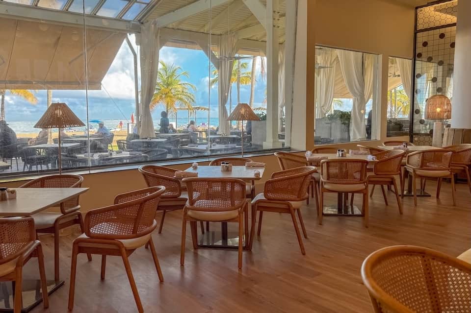 Upscale restaurant interior with ocean views, modern furnishings, and contemporary design
