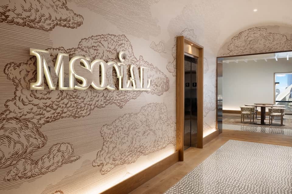 Spa entrance with illuminated 'MSONALI' sign and decorative wall art
