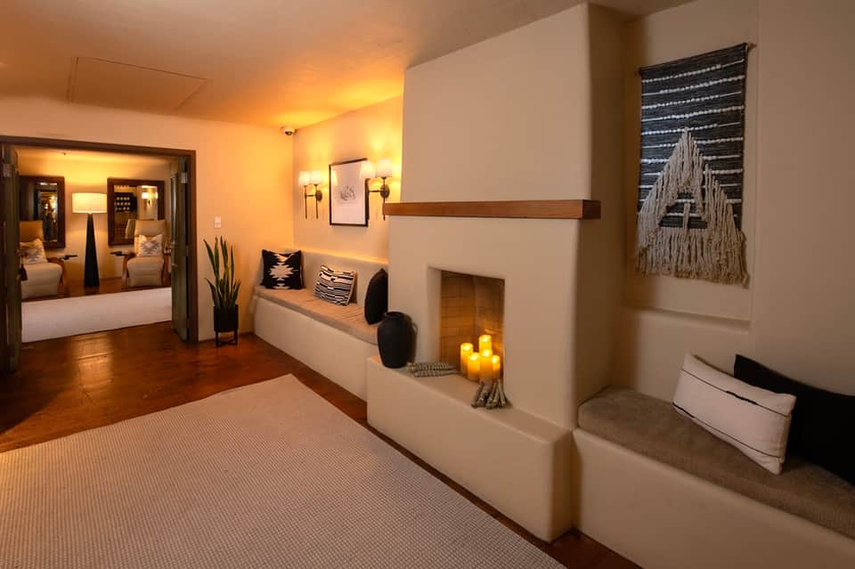 Elegant spa suite entrance with warm lighting, fireplace nook, and luxurious decor details