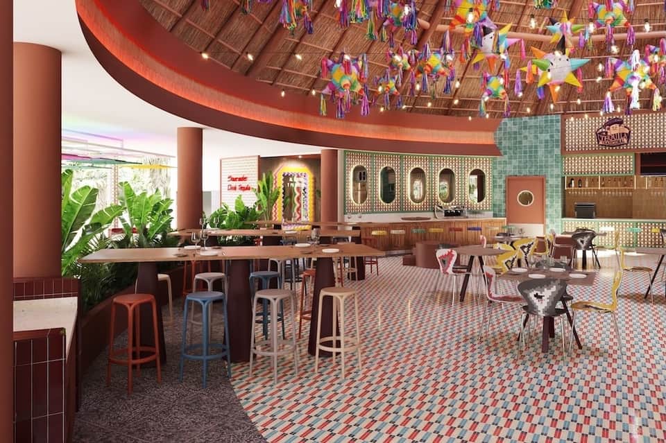 Vibrant resort dining hall with colorful paper decorations, curved red ceiling, tiled floors, tropical plants, and bar seating