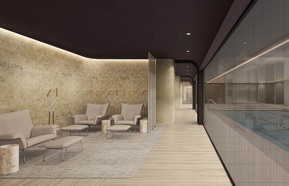 Luxury spa relaxation room with ambient lighting, beige seating, stone accents, and pool view