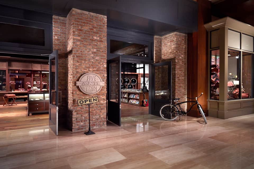 Modern retail corridor with brick archway entrance and contemporary storefront design