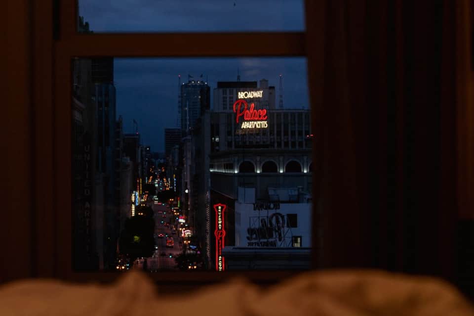 View from hotel window of Broadway street at night with illuminated theater signs