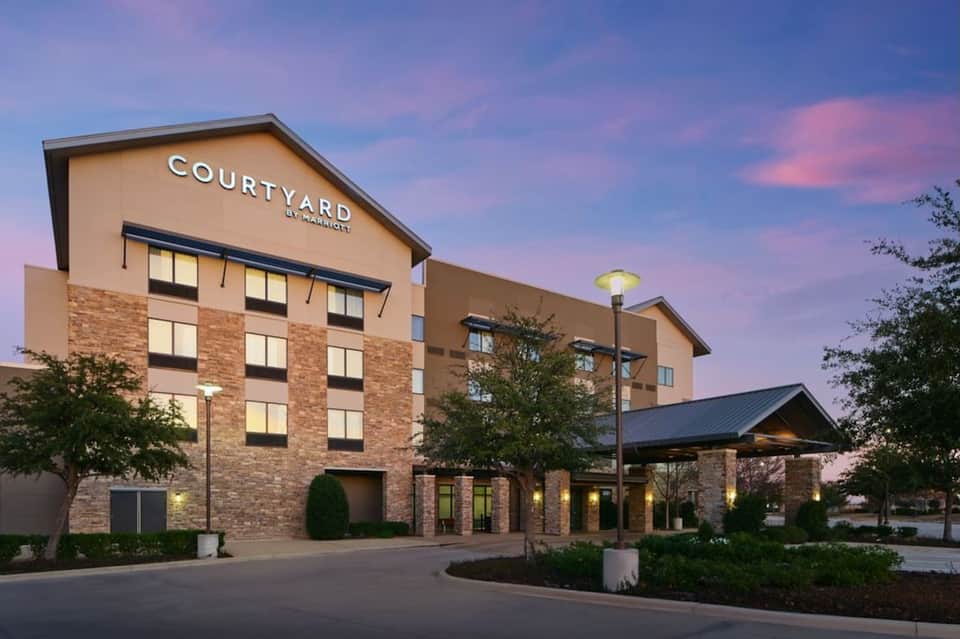 Courtyard by Marriott hotel exterior at twilight with brick facade and entrance canopy
